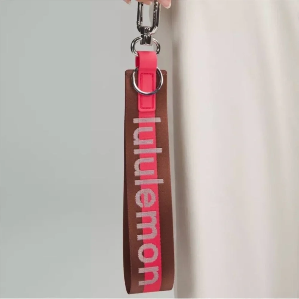 Lululemon Pink and Brown Never lost Word mark Keychain NWOT